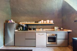 a small kitchen with a refrigerator and a counter at Workation Castle - Casa Tremezzo in Carlazzo