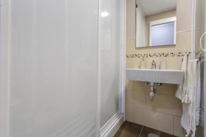 a bathroom with a sink and a mirror at Sea and Sunset Love in San Marcos