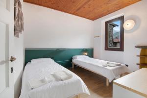 a bedroom with two beds and a mirror at Workation Castle - Casa Tremezzo in Carlazzo