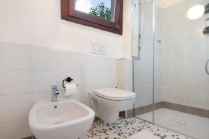 a bathroom with a toilet and a sink and a shower at Workation Castle - Casa Tremezzo in Carlazzo +28 photos