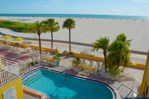 a view of the beach from the balcony of a resort at Page Terrace Beachfront Hotel in St Pete Beach