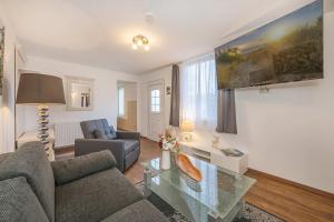 a living room with a couch and a table at Bungalow "Giny" in Bansin