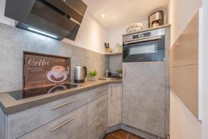 a kitchen with a sink and a stove at Bungalow "Giny" in Bansin