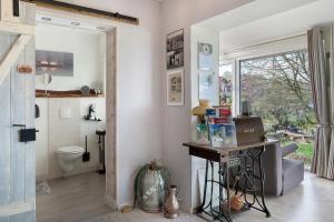 a bathroom with a toilet and a table in a room at Wintergarten Am Thingplatz in Rinteln +37 photos
