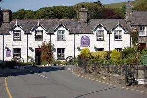 a white building on the side of a road at Bryn Rhedyn Fairbourne in Fairbourne