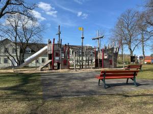 a park with a playground with a slide at Gemütlicher Bungalow in Canow mit Terrasse, Hof und Seenähe in Wustrow