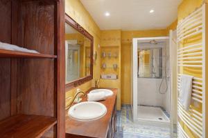 a bathroom with a sink and a toilet and a shower at Maison historique en pierre in Issigeac
