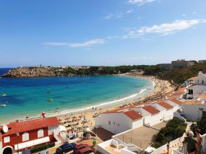 a view of a beach with people in the water at Duplex Laura in Es Mercadal