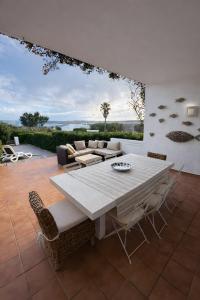 a patio with a white table and chairs at Duplex Laura in Es Mercadal