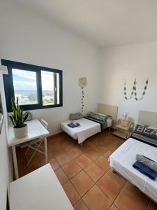 a room with two beds and a window at Duplex Laura in Es Mercadal