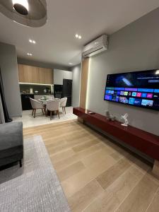 a living room with a large flat screen tv on the wall at Sea Breeze, Polo Residence, Baku, MR in Nardaran