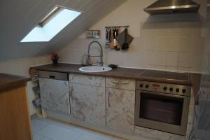 a kitchen with a sink and a stove at Quiet And Renovated Apartment in Schwendi