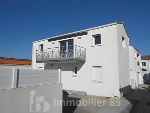 a white building with a balcony on the side at La Maison Du Marché - Balcon in La Tranche-sur-Mer