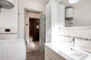 a white bathroom with a sink and a mirror at Casa Tua - Arvier in Arvier +20 photos