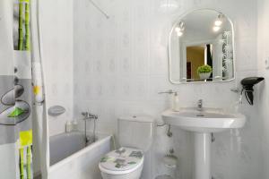 a bathroom with a sink and a toilet and a bath tub at Colina Verde Maspalomas in Maspalomas +29 photos