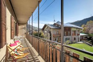 a row of chairs on the balcony of a building at Casa Tua - Arvier in Arvier
