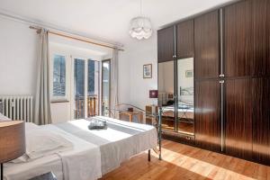 a bedroom with a bed and a large wooden cabinet at Casa Tua - Arvier in Arvier