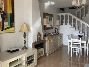 a living room with a table and a staircase at Townhouse with Sea View in Nerja