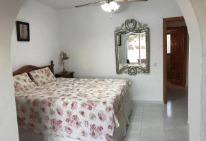 a bedroom with a bed and a mirror at Townhouse with Sea View in Nerja +18 photos