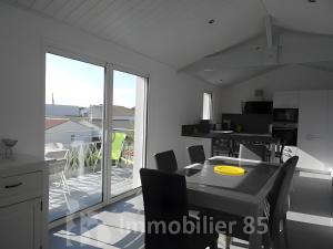 a rendering of a kitchen and dining room with a balcony at La Maison Du Marché - Balcon in La Tranche-sur-Mer +3 photos