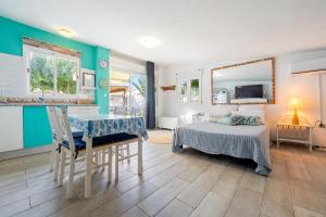 a bedroom with a bed and a desk in it at Beach house in Torredembarra