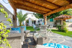 a patio with couches and a table and chairs at Beach house in Torredembarra