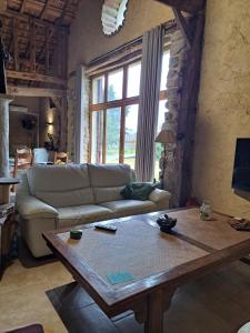 a living room with a couch and a coffee table at Domaine Baraque in Pouillon