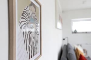 a framed picture of a zebra on a wall at Ferienwohnung Emilia 2 in Garding