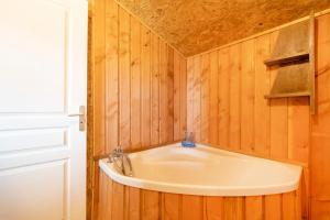a bathroom with a sink in a wooden wall at L'Escale du Dernier Pin in Escalans +19 photos