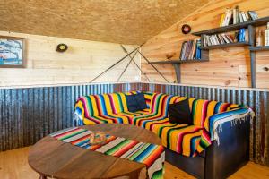 a living room with a couch and a wooden table at L'Escale du Dernier Pin in Escalans