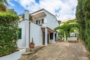 a white house with a driveway at Villa Polina in Capdepera