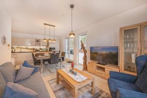 a living room with a couch and a table at FeWo Lieblingsort in Loddin