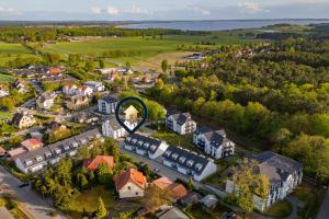 an aerial view of a small town with a round house at FeWo Am Pier 7a in Loddin