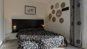 a bedroom with a bed with a black and white comforter at Virginia N 203 ST2 in Grasse