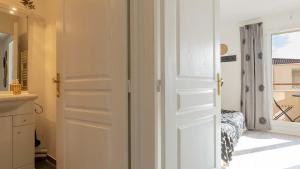 a white door in a room with a window at Virginia N 203 ST2 in Grasse +4 photos