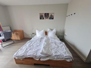 a bedroom with a large bed with white sheets and pillows at Orth A5 in Orth