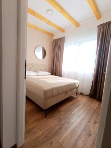 a bedroom with a bed and a window at Kucica na Drini MINJA in Višegrad
