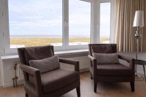 two chairs in a room with a large window at Anna's Haven, Knokke in Knokke-Heist