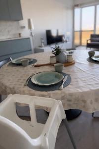 a table with a plate and a chair in a room at Anna's Haven, Knokke in Knokke-Heist +14 photos