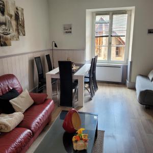 a living room with a couch and a table at Riquewihr in Riquewihr +4 photos