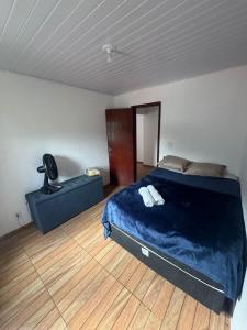 a bedroom with a bed and a chair in it at Família Ebeneze in Santa Maria Madalena