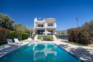 a house with a swimming pool in front of a house at Blue Pine Villa in Marathon