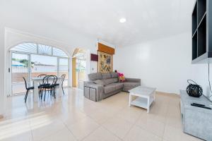 a living room with a couch and a table at Chalet del Lago in Torrevieja