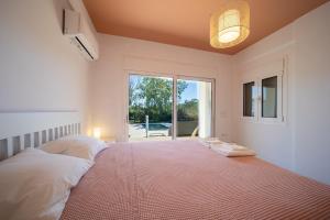a bedroom with a large bed with a large window at Blue Pine Villa in Marathon +46 photos
