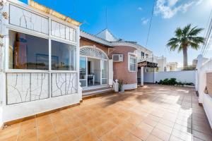 an exterior view of a house with a patio at Chalet del Lago in Torrevieja