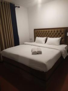 a bedroom with a bed with two towels on it at Thotupala Eco Lodge in Nilweligama +14 photos