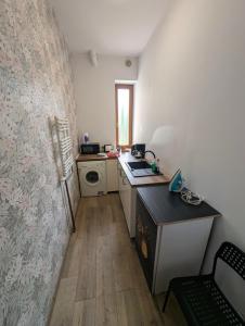 a small kitchen with a sink and a stove at Hostel Kalinowskiego in Żary