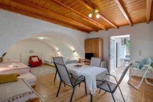 a living room with a table and chairs and a couch at Traditional House in Velies in Áyios Sarándos