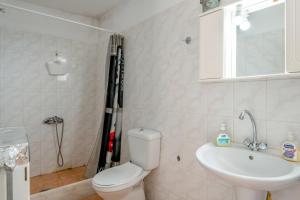 a bathroom with a toilet and a sink at Traditional House in Velies in Áyios Sarándos