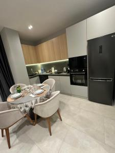 a kitchen with a table and chairs and a refrigerator at Sea Breeze, Polo Residence, Baku, MR in Nardaran